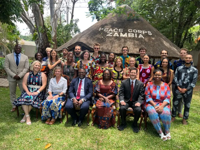 Natalie with Volunteers and leadership under the same Peace Corps Zambia insaka, twenty years later